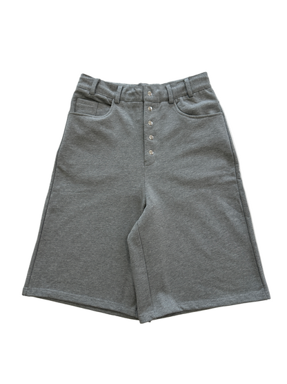 Gray shorts with button details on a white background